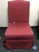 A Delcor bedroom chair in red fabric