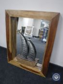 A contemporary mango wood wall mirror and a driftwood & metal yacht