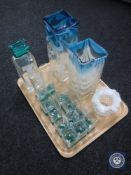 A tray of two-tone glass decanter together with twelve matching glasses and three vases