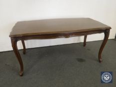 A shaped French coffee table on cabriole legs