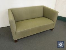 A mid 20th century two-seater settee in green