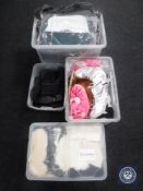 Four plastic storage boxes containing shoes,