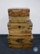 Three graduated mango wood storage boxes