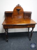 A late 19th century walnut inlaid writing table fitted three drawers