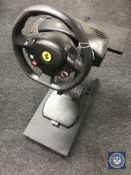 A Thrustmaster XBox steering wheel with control pedals