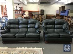 A green leather three-piece suite comprising three seater settee,