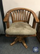 A pine swivel office chair,