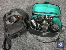 A Nikon Nikkormat camera with lens in bag together with a Nikon F-301 camera with lenses in case.