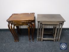 A nest of three shaped walnut tables and a nest of three oak tables
