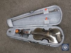 A black Stentor Harlequin violin and bow in a fitted case
