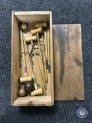 An early 20th century miniature croquet set in pine box
