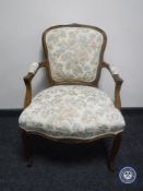 A continental armchair on cabriole legs in floral fabric