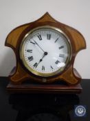 A shaped inlaid mahogany mantel clock with key