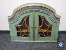 A painted double door wall cabinet