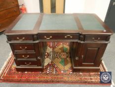 A reproduction mahogany pedestal partner's desk,