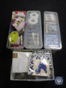 Three plastic storage boxes and a basket containing napkins