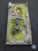 An electric train track with buildings mounted on a board