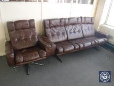 A mid 20th century brown button leather three seater settee and armchair
