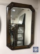 An early 20th century octagonal oak framed mirror
