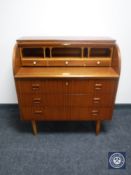 A mid 20th century barrel fronted bureau
