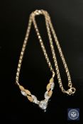 A two-tone gold diamond set necklace, a central brilliant-cut diamond of approximately 0.