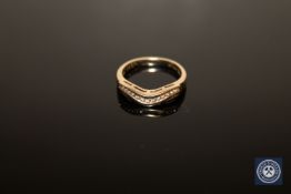 A 9ct gold diamond ring, fourteen brilliant-cut diamonds within a serpentine channel setting,