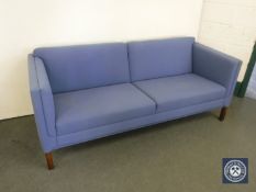 A late 20th century settee in blue fabric