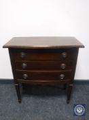 A mid 20th century three drawer chest