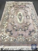 A pink fringed Chinese embossed carpet