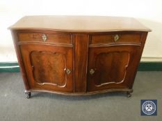 An antique mahogany serpentine fronted sideboard