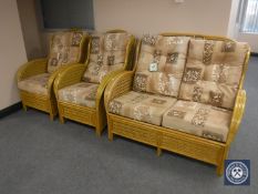 A three-piece bamboo and wicker conservatory suite