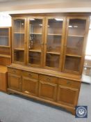 A contemporary Stag oak four door glazed door bookcase