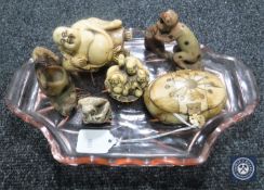 Two soapstone figures together with a carved netsuke,