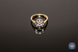 An 18ct gold diamond cluster ring, the central stone estimated at 0.