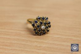 An 18ct gold sapphire and diamond cluster ring, 7.