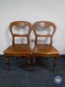 A pair of Victorian mahogany hall chairs