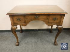 A Georgian style walnut three drawer lowboy, width 93 cm.