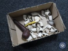A box of assorted clay pipes