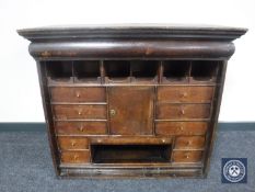 A Georgian oak secretaire cabinet top fitted with ten drawers and a cupboard