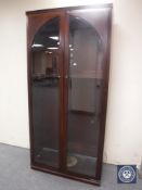 A mahogany double door glazed bookcase
