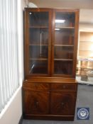 An inlaid mahogany glazed door bookcase