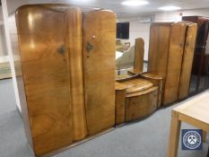 A mid 20th century walnut three-piece bedroom suite