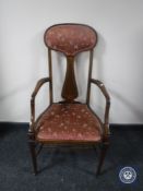 A Victorian inlaid mahogany armchair in pink floral brocade