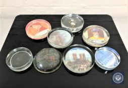 A box containing six vintage glass paperweights,