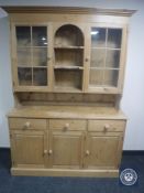 A stripped pine kitchen dresser