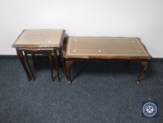 A mahogany glass and leather-topped coffee table together with matching nest of three tables