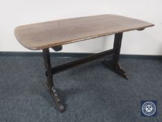 An Ercol elm refectory dining table