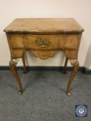 A Georgian style burr walnut low boy, width 59 cm.