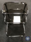 A nest of three 20th century tubular metal glass topped tables