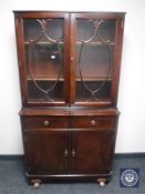 An inlaid glazed door bookcase with cupboards and drawers beneath